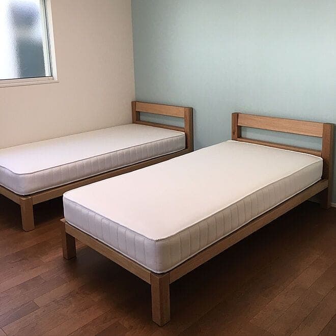 Minimal twin-sharing room with mattresses